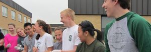 Group of people gathered outdoors to educate extension program awareness.