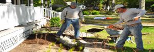 Two people preparing rain garden for stormwater management.